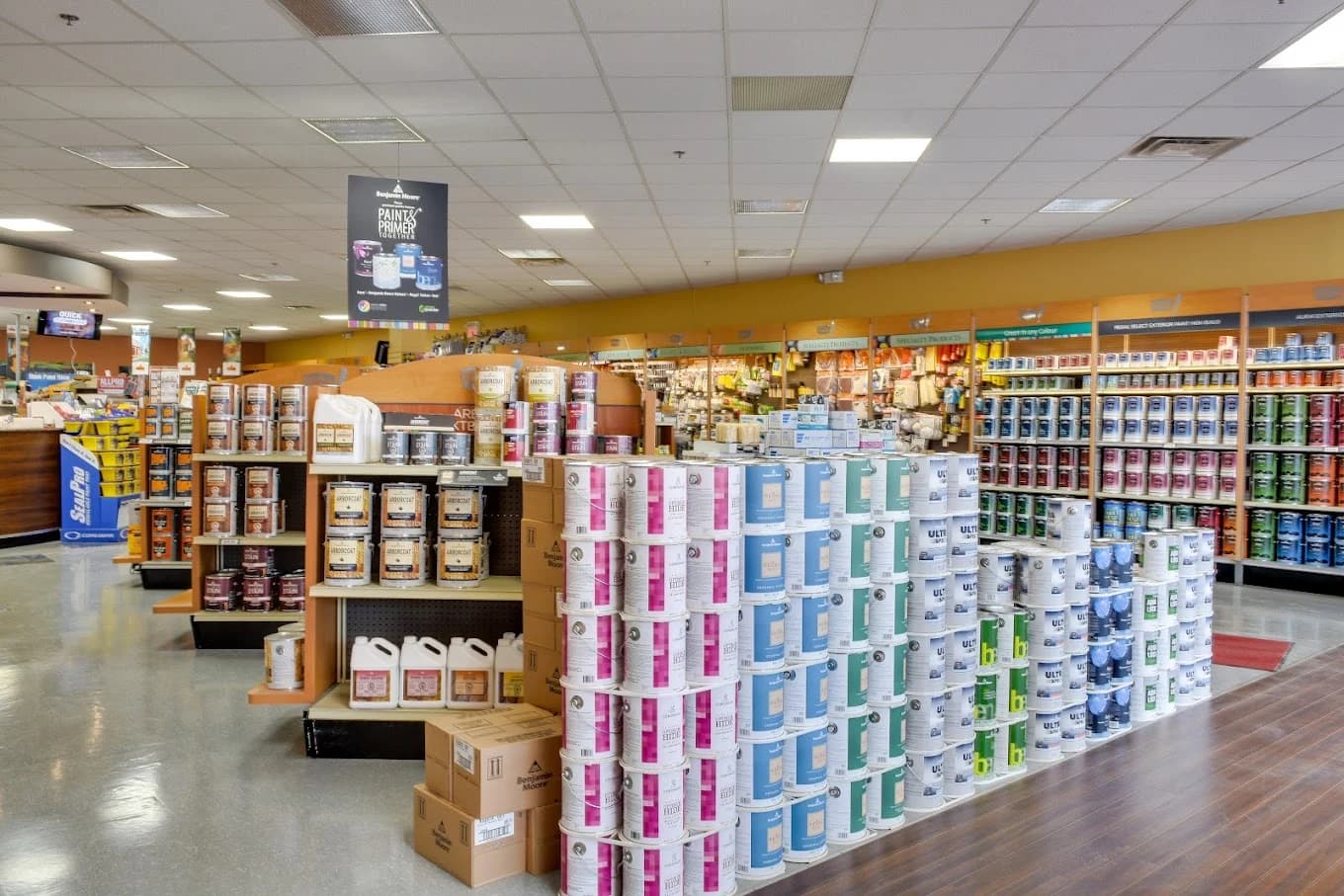 Paint store interior with Benjamin Moore paint displays and shelves of painting supplies
